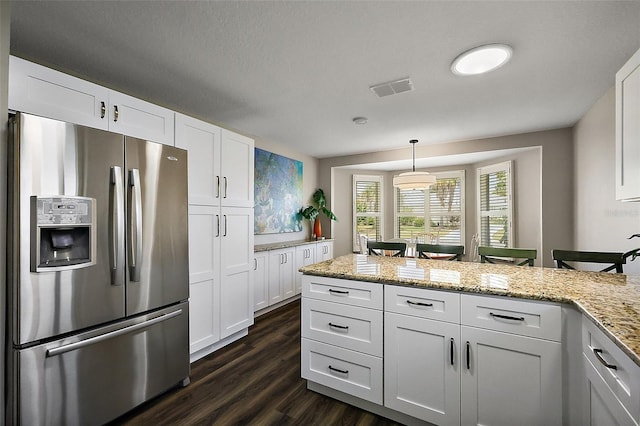 kitchen featuring white cabinetry, visible vents, stainless steel fridge, and dark wood-style flooring