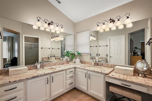 full bathroom with a sink, tile patterned floors, a stall shower, visible vents, and vaulted ceiling