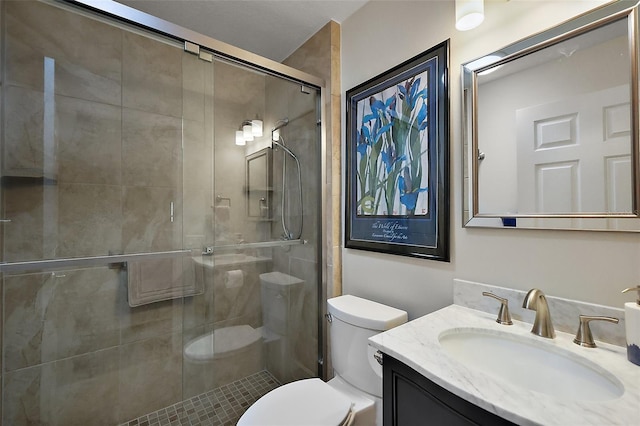 full bath featuring a stall shower, toilet, and vanity