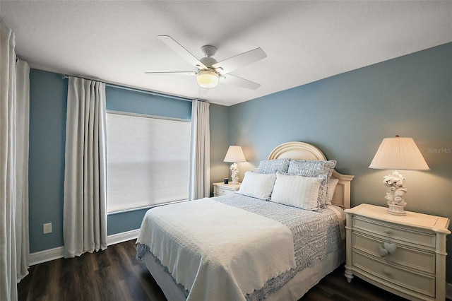 bedroom with dark wood-style floors, ceiling fan, and baseboards