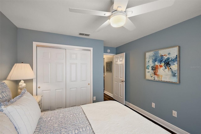 bedroom with a closet, visible vents, a ceiling fan, and baseboards
