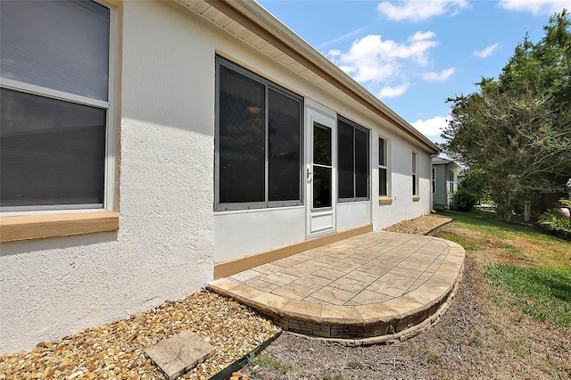view of home's exterior featuring stucco siding and a patio area
