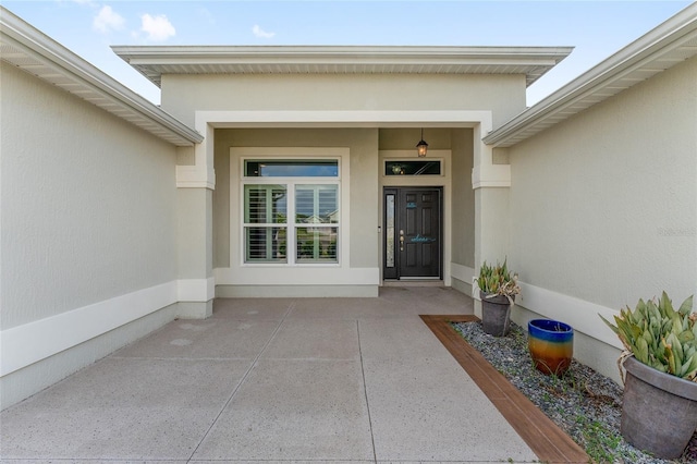 view of exterior entry with stucco siding