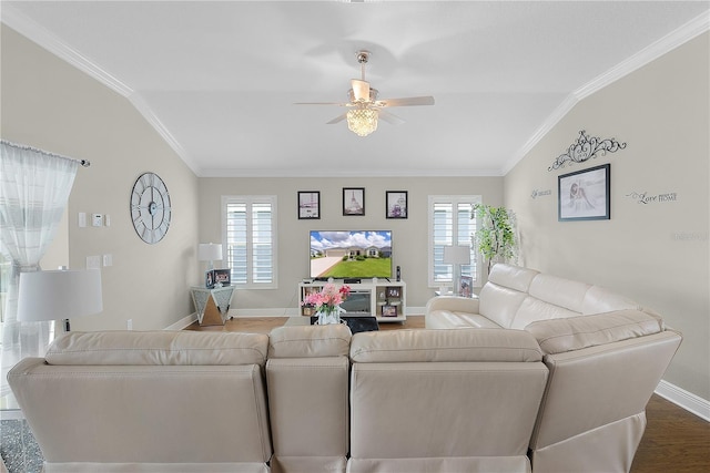 living area with crown molding, baseboards, plenty of natural light, and wood finished floors