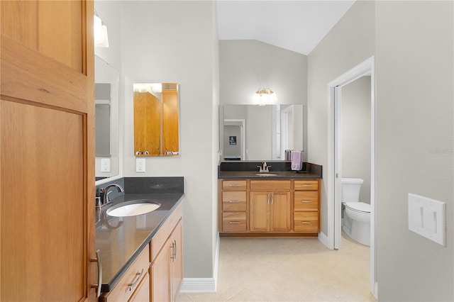 full bath featuring a sink, lofted ceiling, tile patterned floors, and two vanities