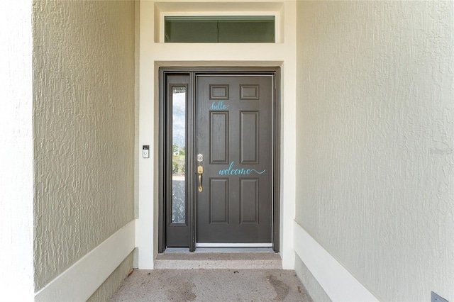 entrance to property featuring stucco siding