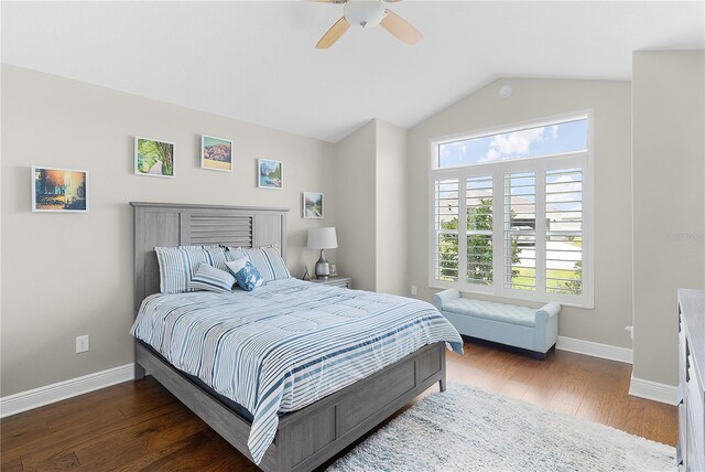 bedroom with baseboards, ceiling fan, wood finished floors, and lofted ceiling