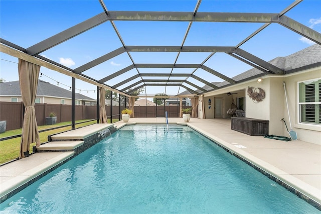 view of swimming pool featuring a patio, a fenced backyard, a fenced in pool, a ceiling fan, and a lanai