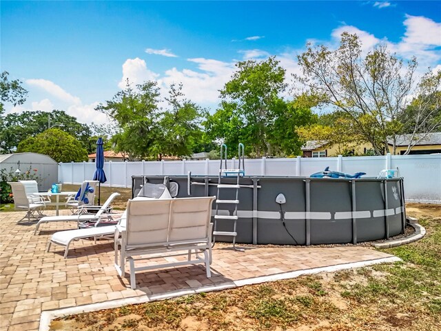 1001 N Lakeshore Blvd, Howey In The Hills, FL 34737 - view of patio / terrace featuring a fenced backyard and a fenced in pool