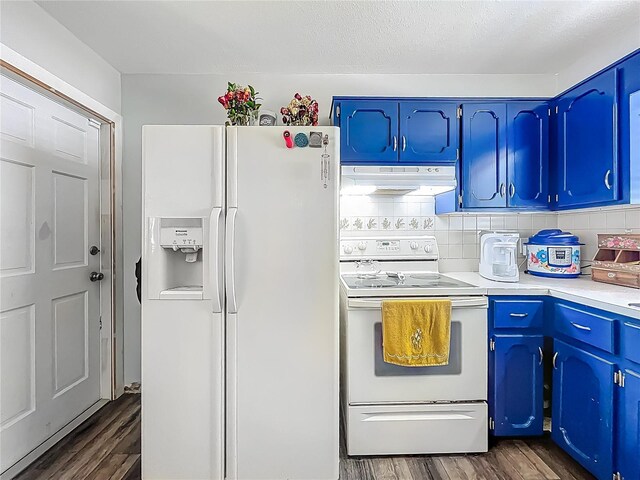 1001 N Lakeshore Blvd, Howey In The Hills, FL 34737 - kitchen featuring dark wood-style flooring, white appliances, light countertops, and under cabinet range hood