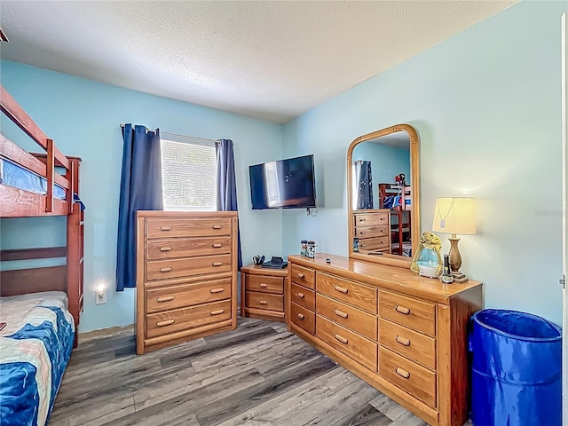 1001 N Lakeshore Blvd, Howey In The Hills, FL 34737 - bedroom featuring a textured ceiling and wood finished floors
