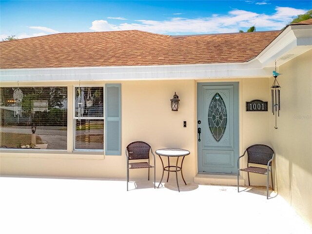 1001 N Lakeshore Blvd, Howey In The Hills, FL 34737 - view of exterior entry featuring a shingled roof and stucco siding