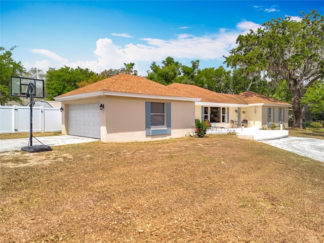 1001 N Lakeshore Blvd, Howey In The Hills, FL 34737 - single story home featuring driveway, fence, a garage, stucco siding, and a front yard