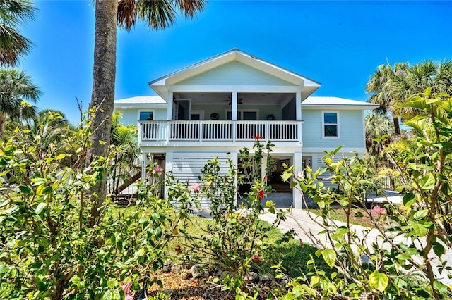 beach home featuring a carport and a ceiling fan