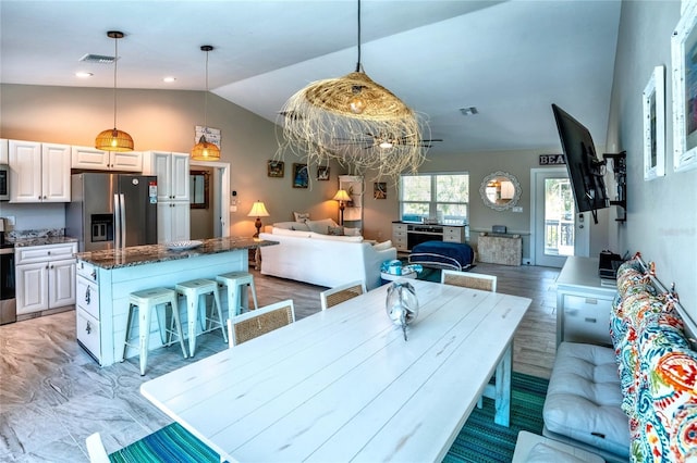 dining room with visible vents and lofted ceiling