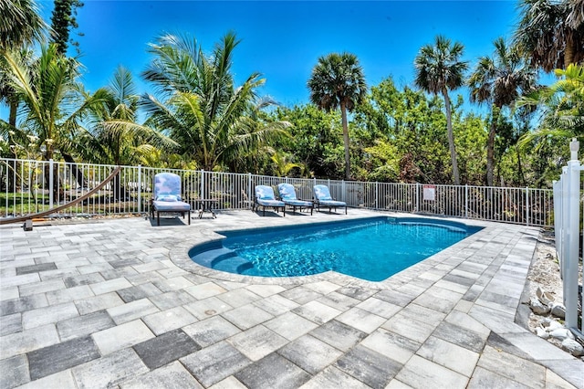 view of pool featuring fence, a fenced in pool, and a patio area