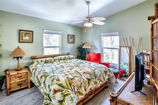 bedroom featuring a ceiling fan and multiple windows
