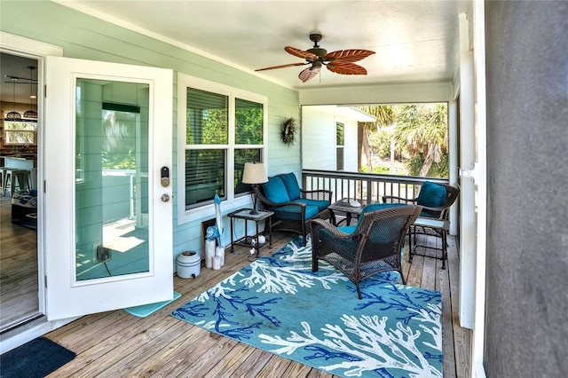 sunroom / solarium featuring an outdoor hangout area, a ceiling fan, and a healthy amount of sunlight