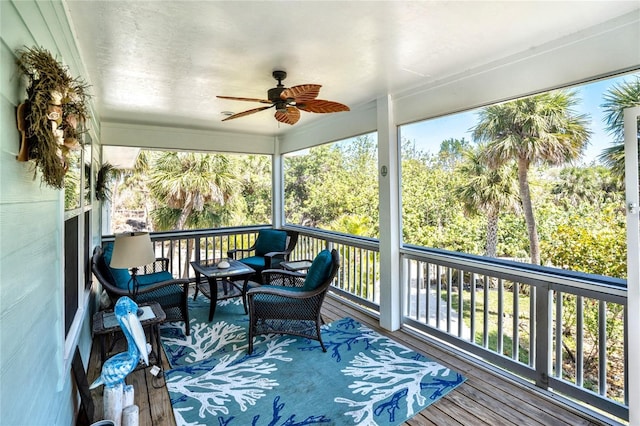 sunroom / solarium featuring ceiling fan