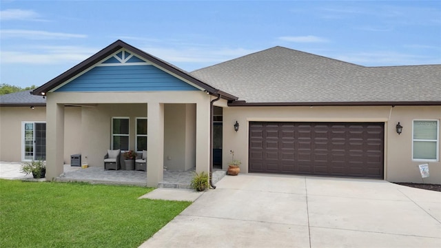 view of front of house with stucco siding, driveway, and an attached garage