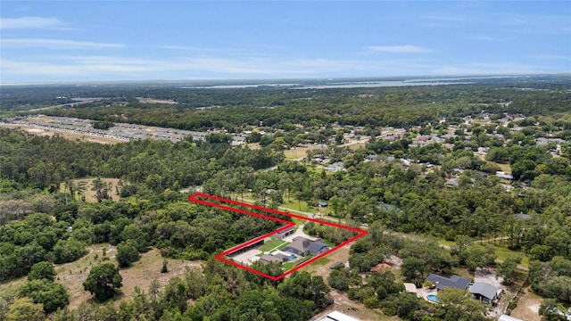 drone / aerial view featuring a wooded view