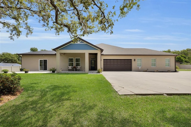 ranch-style home featuring a garage, a front lawn, stucco siding, and concrete driveway