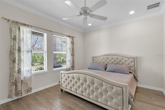 bedroom featuring visible vents, baseboards, and multiple windows
