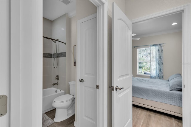 bathroom featuring connected bathroom, toilet, visible vents, ornamental molding, and wood finished floors