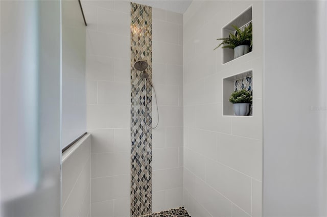 full bathroom with a tile shower