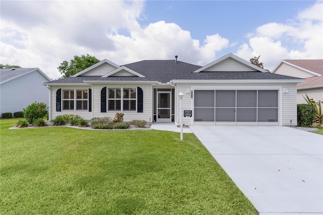 ranch-style house featuring roof with shingles, an attached garage, driveway, and a front yard
