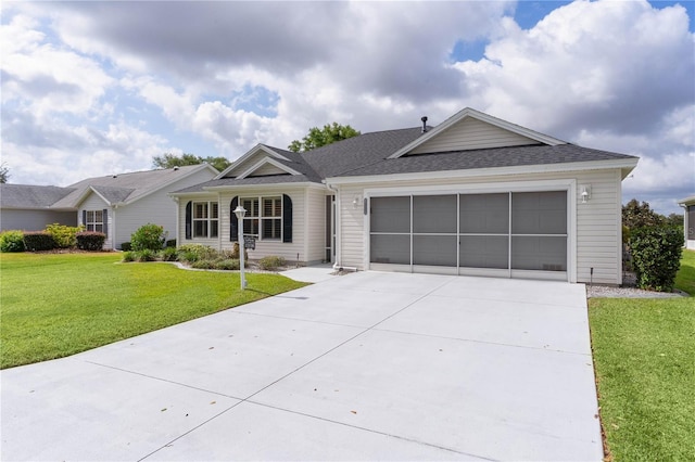 ranch-style home with roof with shingles, an attached garage, driveway, and a front yard