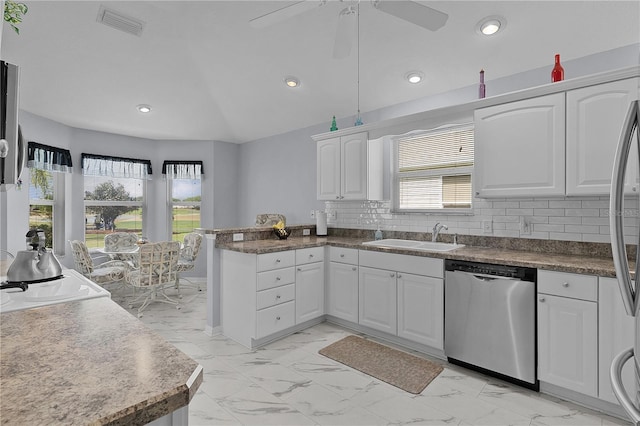 kitchen with a sink, marble finish floor, white cabinetry, a peninsula, and stainless steel dishwasher