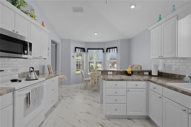 kitchen featuring white range with electric cooktop, stainless steel microwave, white cabinetry, and marble finish floor