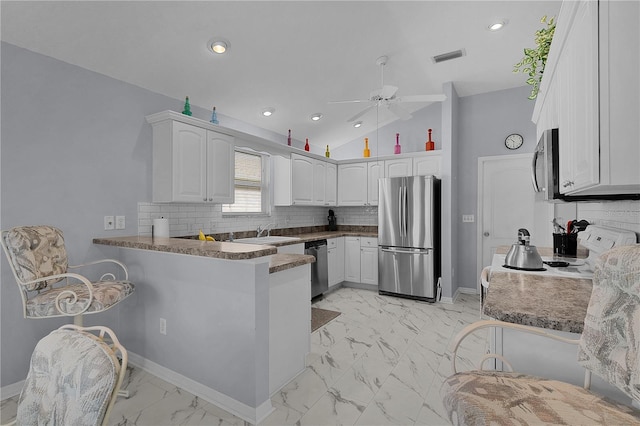 kitchen with ceiling fan, white cabinets, a peninsula, marble finish floor, and stainless steel appliances