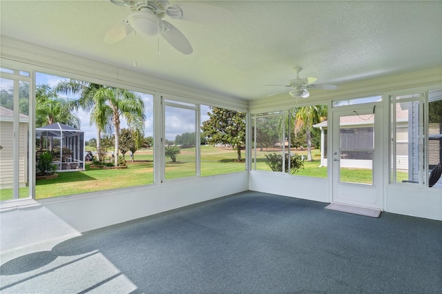 unfurnished sunroom featuring ceiling fan