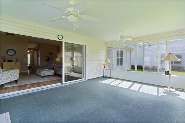 unfurnished sunroom featuring ceiling fan and visible vents