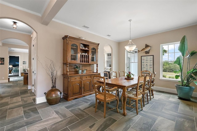 6905 Clayton St, Mount Dora, FL 32757 - dining room with arched walkways, baseboards, and crown molding