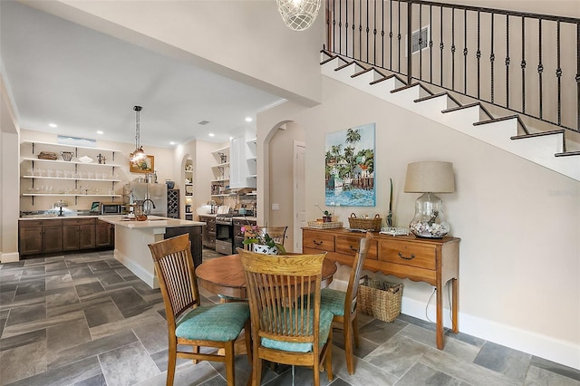 6905 Clayton St, Mount Dora, FL 32757 - dining space featuring baseboards, arched walkways, recessed lighting, and a high ceiling