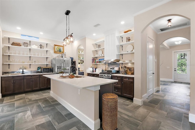 6905 Clayton St, Mount Dora, FL 32757 - kitchen with open shelves, a sink, stainless steel appliances, arched walkways, and dark brown cabinetry