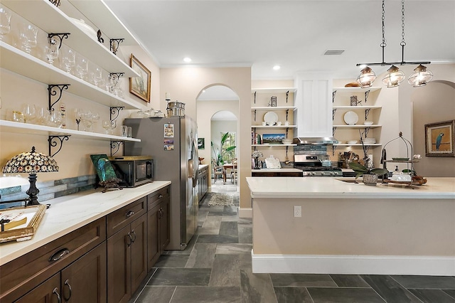 6905 Clayton St, Mount Dora, FL 32757 - kitchen with open shelves, stainless steel appliances, arched walkways, dark brown cabinetry, and stone finish floors