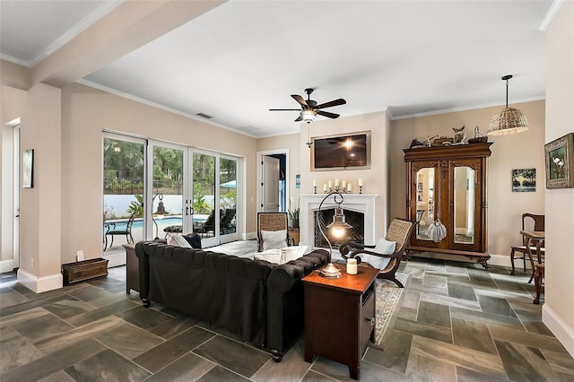 6905 Clayton St, Mount Dora, FL 32757 - living area featuring baseboards, a fireplace, ceiling fan, dark stone finish floors, and ornamental molding