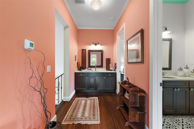 6905 Clayton St, Mount Dora, FL 32757 - hallway featuring dark wood finished floors, ornamental molding, and a sink