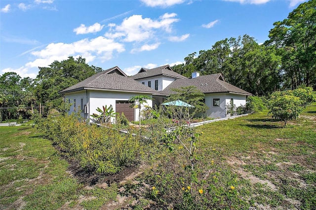 6905 Clayton St, Mount Dora, FL 32757 - view of front of property with a garage, stucco siding, and a front lawn