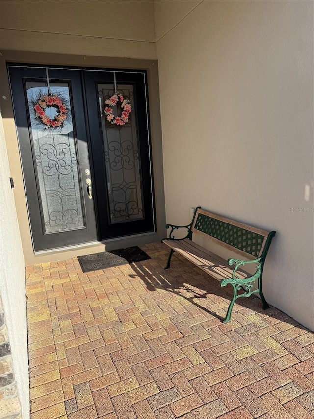 view of exterior entry featuring stucco siding