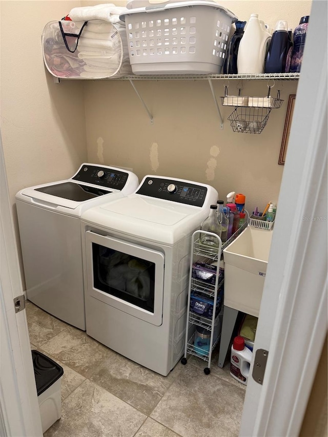 laundry room featuring a sink, laundry area, and washing machine and dryer