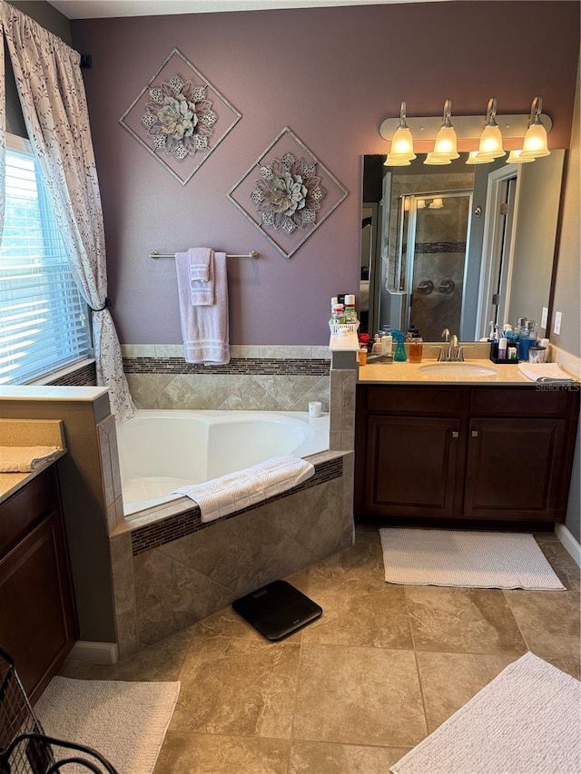 bathroom with a garden tub, tile patterned floors, a shower stall, and vanity
