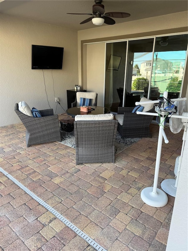 view of patio with a ceiling fan and outdoor lounge area