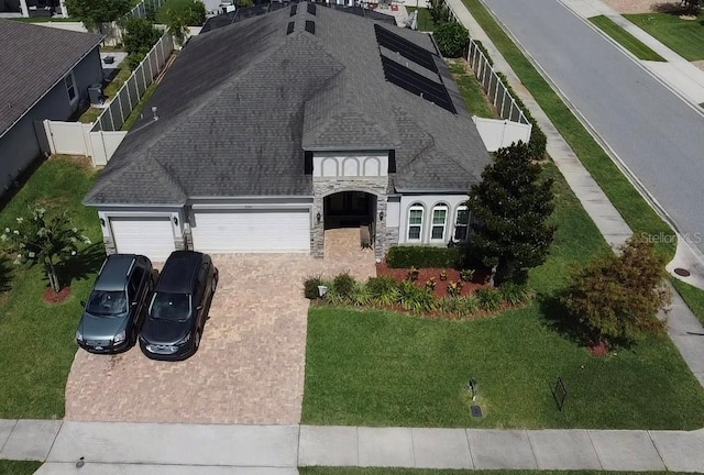 2504 Cavender Creek Rd, Minneola, FL 34715 - view of front of home with a garage, decorative driveway, stone siding, and roof with shingles