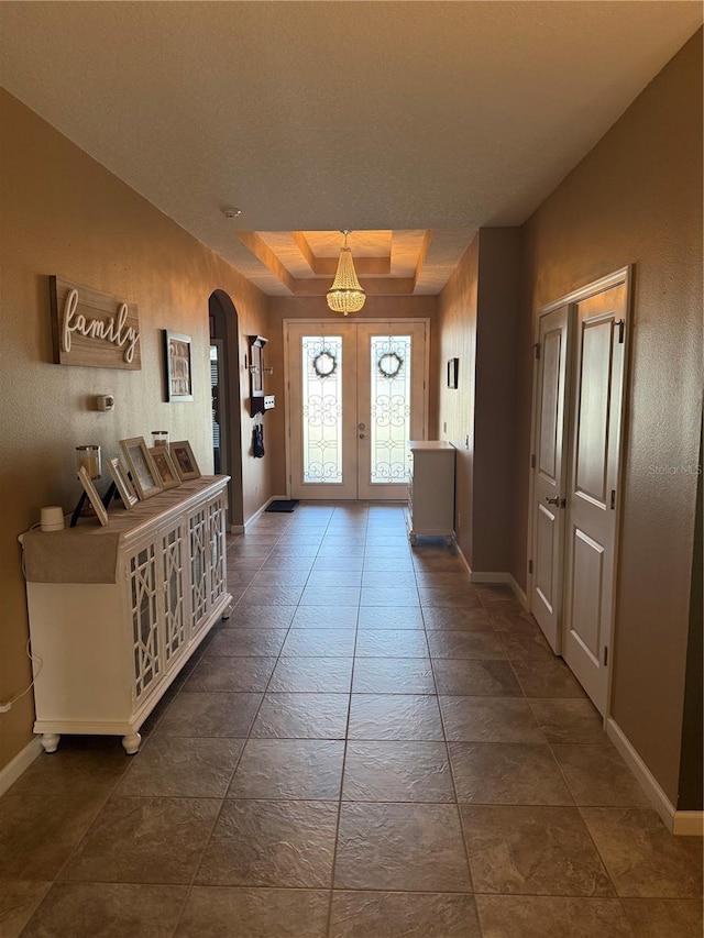 2504 Cavender Creek Rd, Minneola, FL 34715 - foyer entrance featuring arched walkways, french doors, and a chandelier