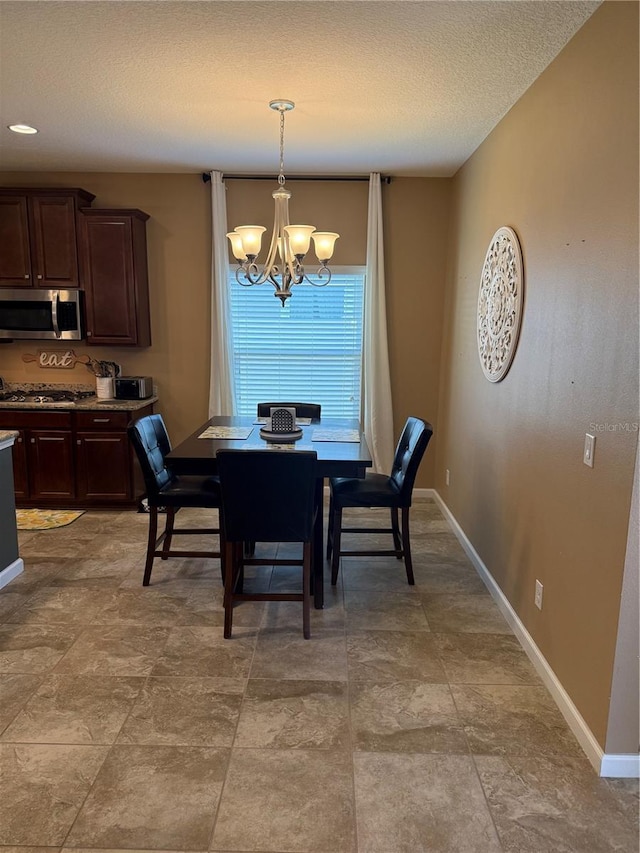 2504 Cavender Creek Rd, Minneola, FL 34715 - dining area featuring a chandelier and a textured ceiling